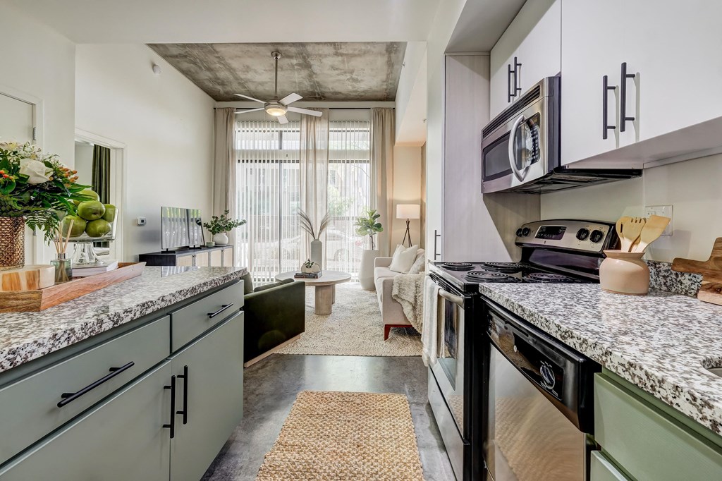 a kitchen with granite counter tops and a stove and a window