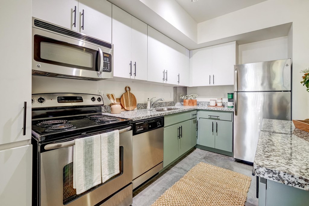 a kitchen with stainless steel appliances and white cabinets