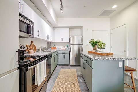 a modern kitchen with stainless steel appliances and gray counters