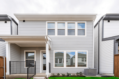 the exterior of a white house with windows
