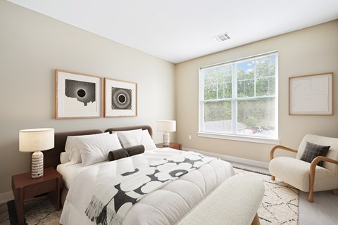 A bedroom with a large bed and two lamps.