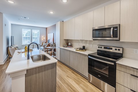 A modern kitchen with a stainless steel oven and microwave.