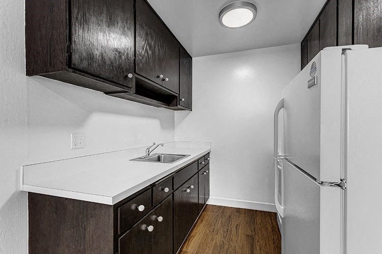 a kitchen with a refrigerator and a sink
