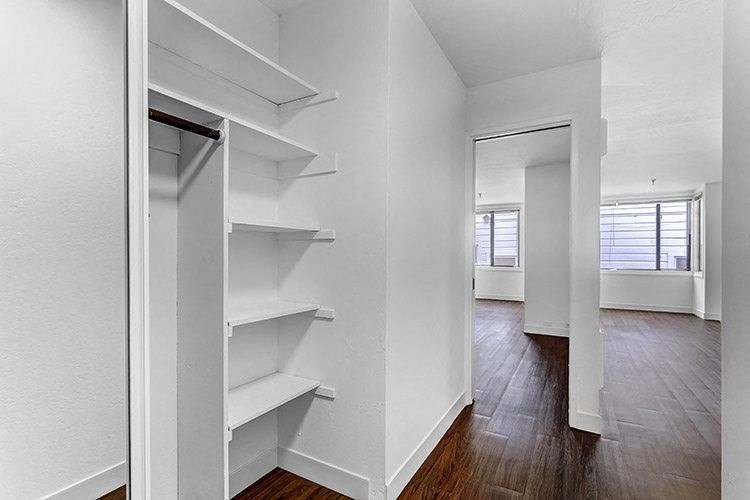 a walk in closet in a bedroom
