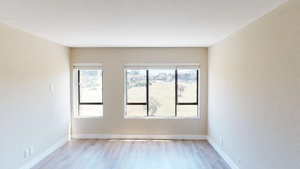 an empty room with three windows