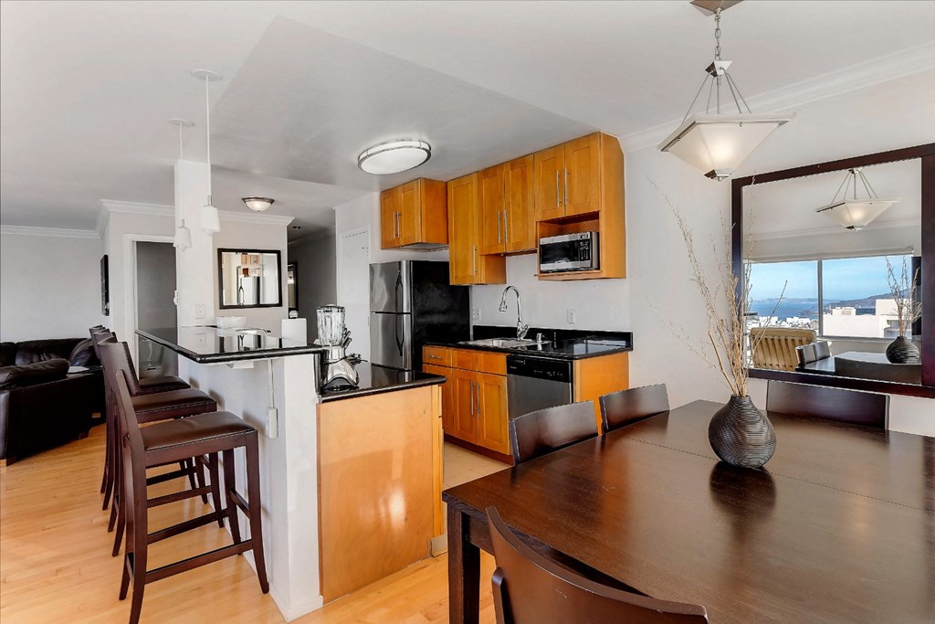 a kitchen and dining area with a wooden table and chairs