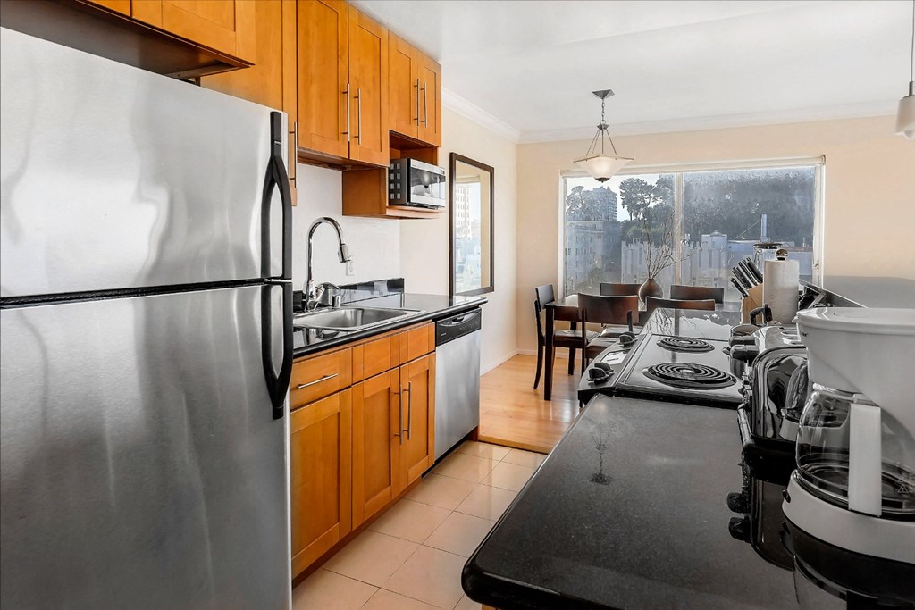 a kitchen with wooden cabinets and stainless steel appliances
