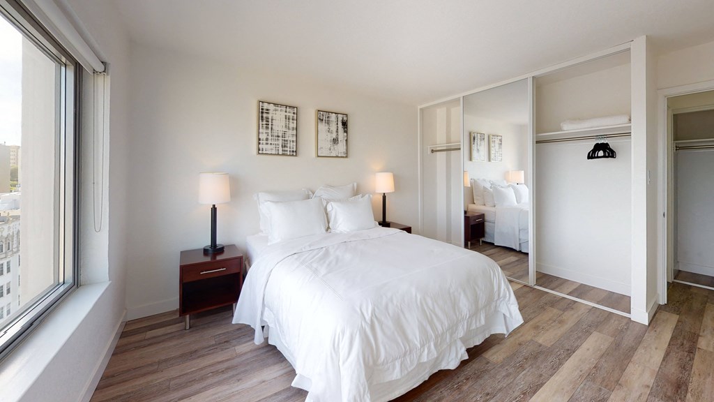 a bedroom with a large bed and a large window