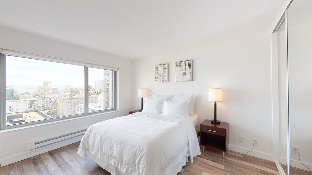 a bedroom with a large bed and a large window