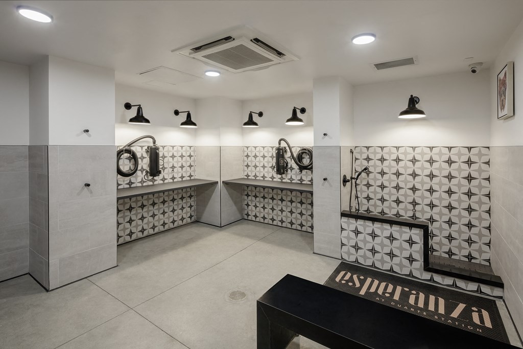 a large room with white tiles and a bench with a sign that says ecstasy