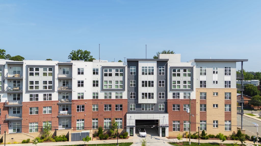 A large multi-story building with a mix of brick and white exterior walls.
