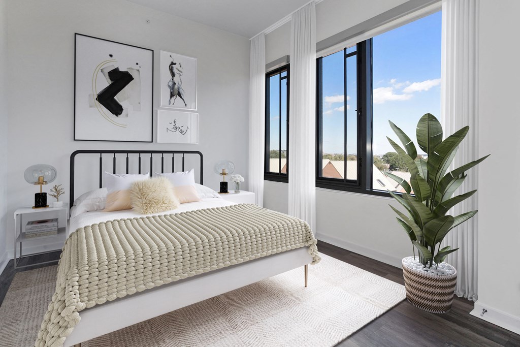 a bedroom with a bed and a large window