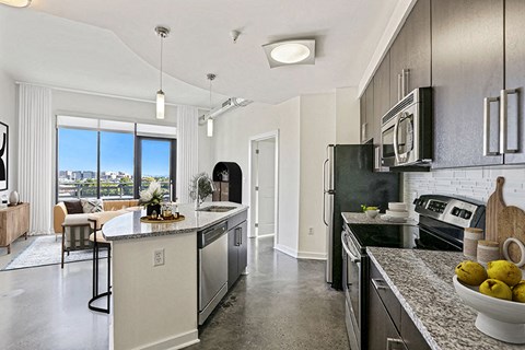 an open kitchen with stainless steel appliances and granite counter tops