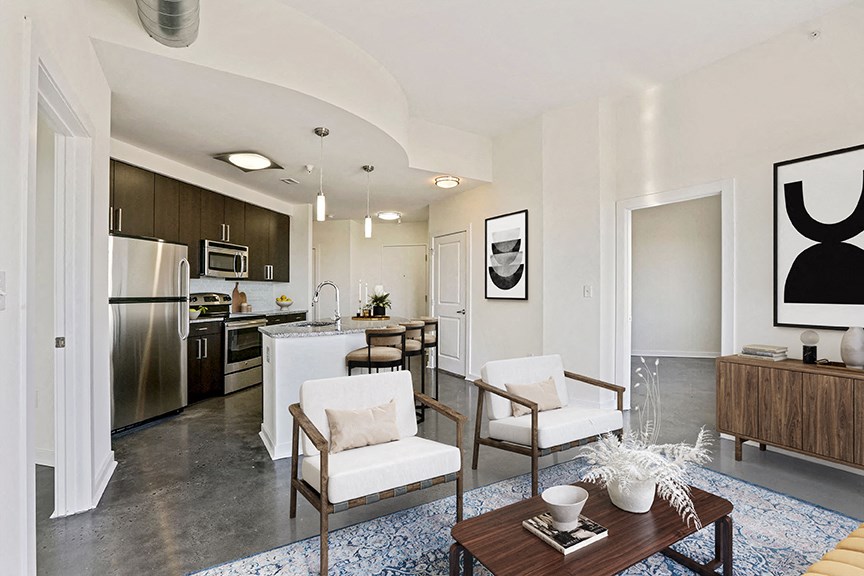 a living room and kitchen with a table and chairs