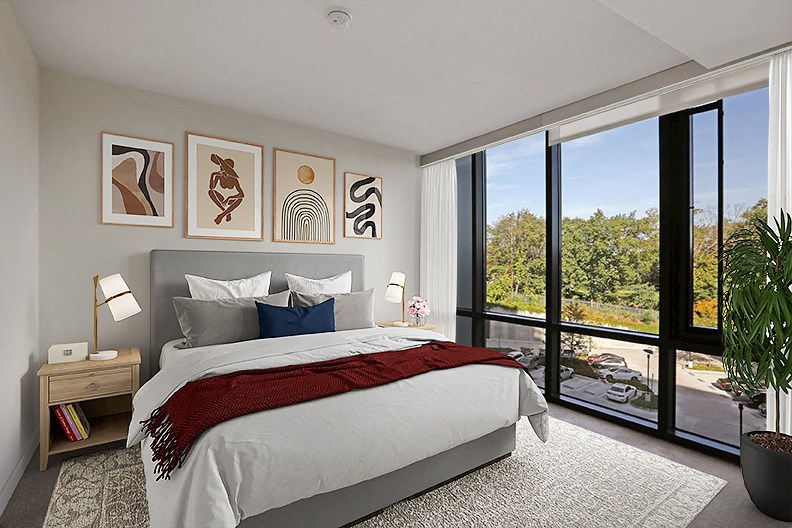 a bedroom with a bed and a large window