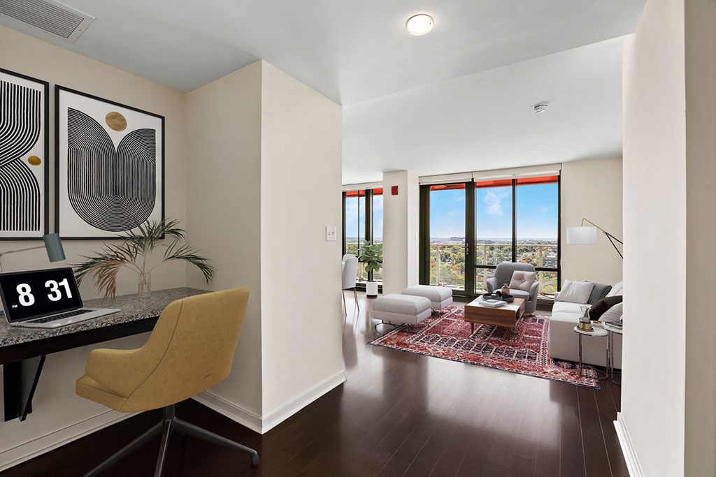 a living room with a couch and a chair and a desk