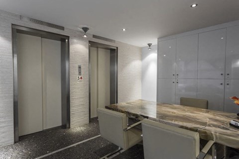 a meeting room with a wooden table and white chairs