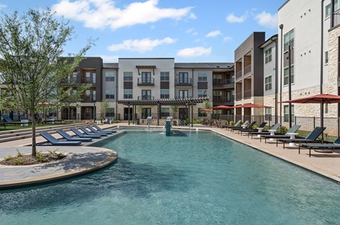 A swimming pool in front of apartment buildings.