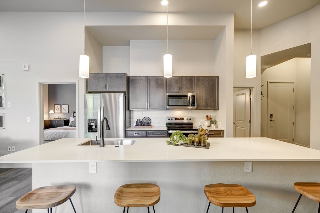 large kitchen island with view of kitchen and bedroom