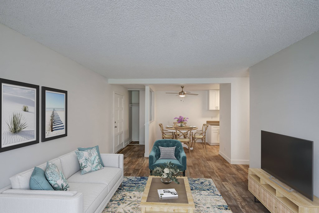 a living room with a couch and a chair and a tv