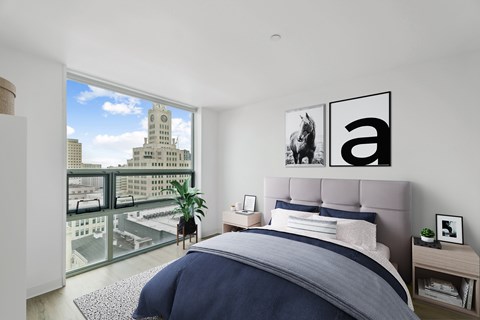 A bedroom with a large bed and a view of the city.