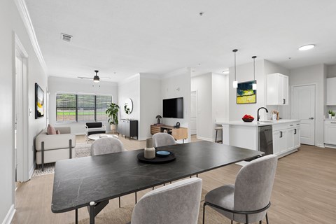 A modern dining room with a black table and grey chairs.