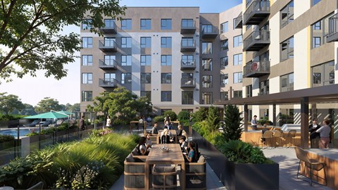 A modern apartment complex with a communal outdoor dining area.