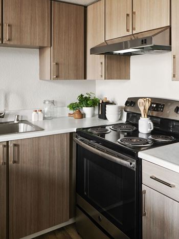 A modern kitchen with a black stove top oven.