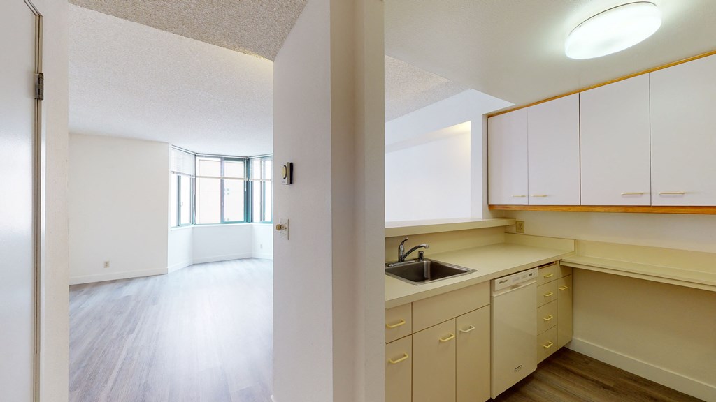 an empty kitchen and living room in an apartment