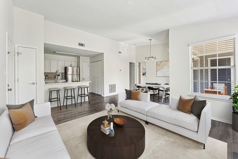 A living room with a white couch and a coffee table.