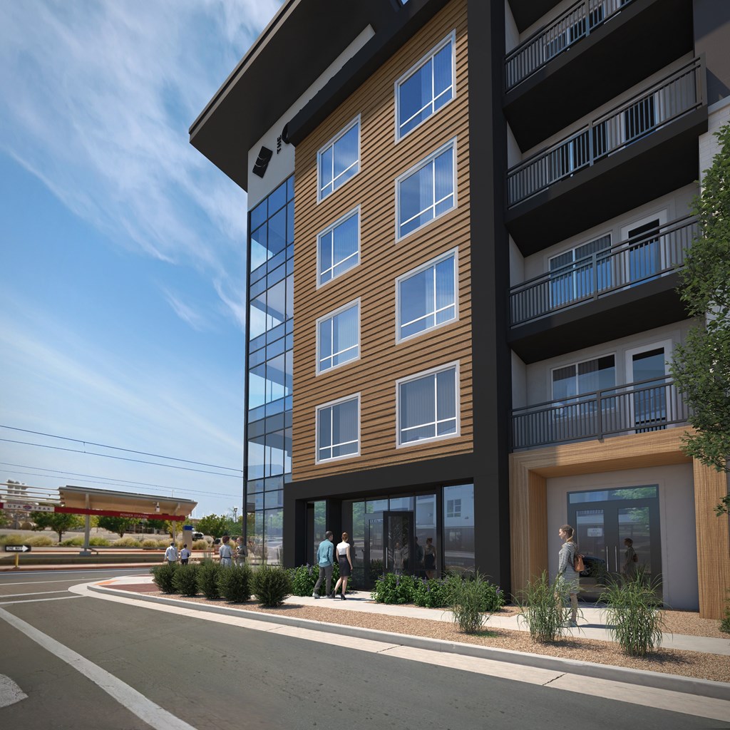 A modern apartment building with balconies and a clear blue sky.