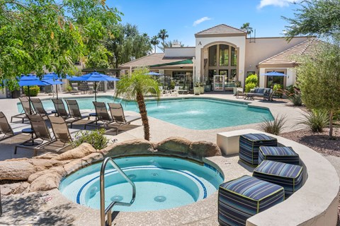 A pool with a hot tub in the middle of it.