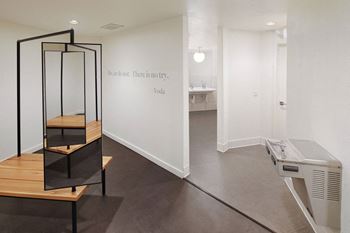 a room with a glass display case and a printer on the floor