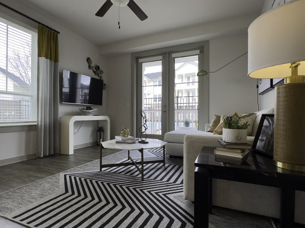 A TV Mounted on Wall Next to Balcony Door