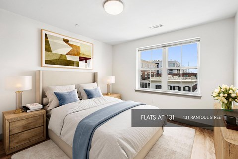 A bedroom with a large bed and a view of the city.