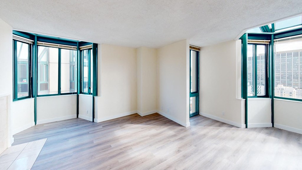 a bedroom with hardwood floors and white walls