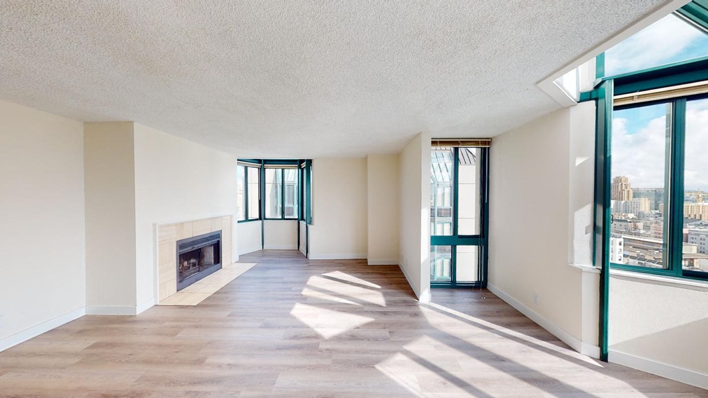 a living room with a fireplace and large windows