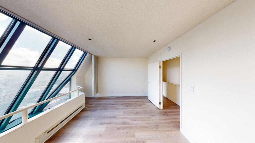 an empty apartment with white walls and large windows