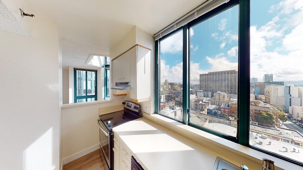 a kitchen with a large window and a city view