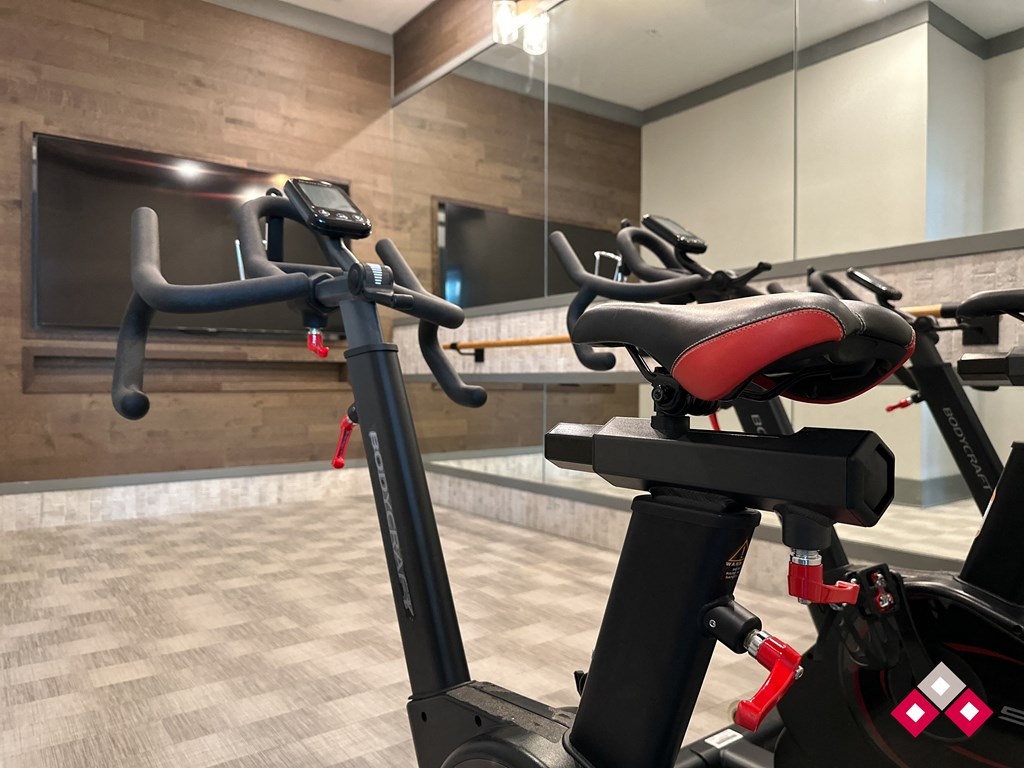 a row of exercise bikes in a gym