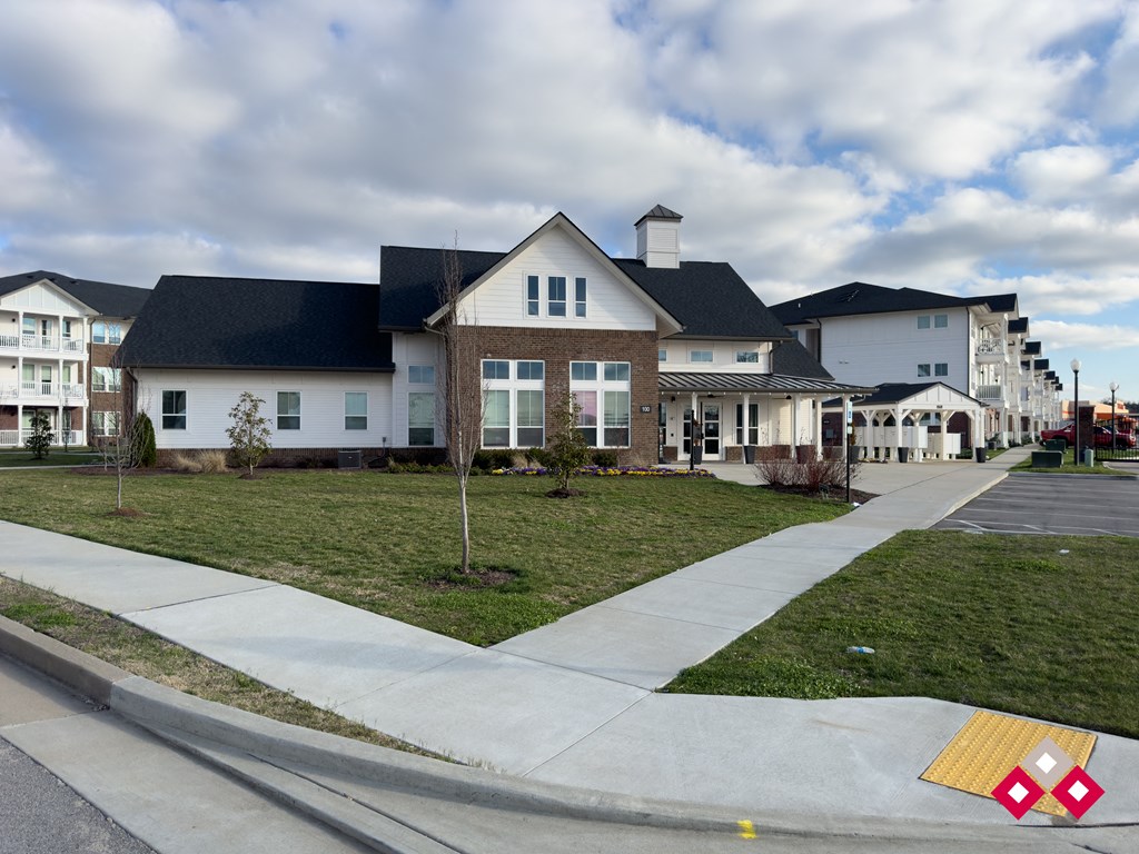 a large white house with a sidewalk in front of it