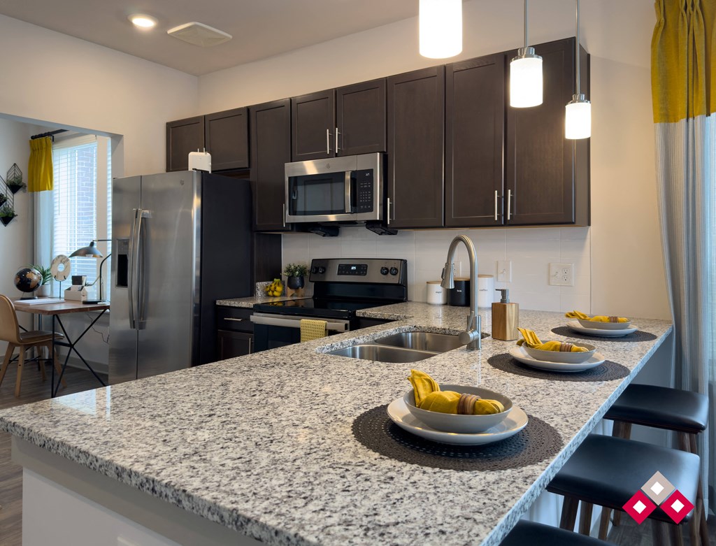 a kitchen with granite counter tops and stainless steel appliances