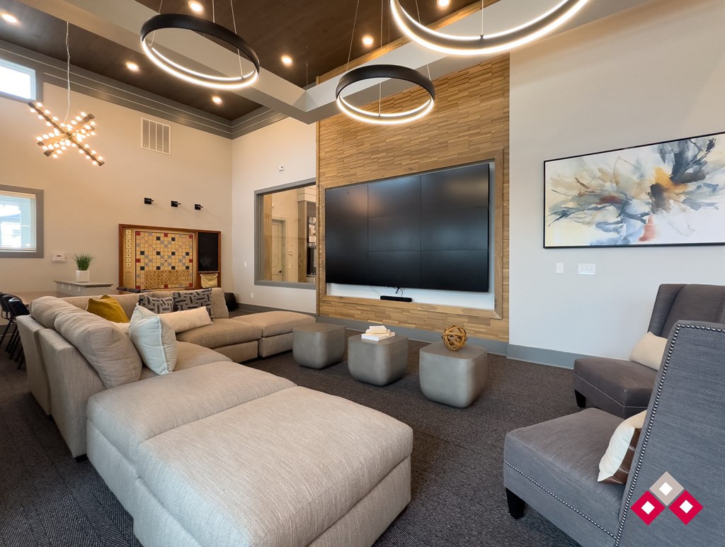 a living room with couches and a tv on the wall