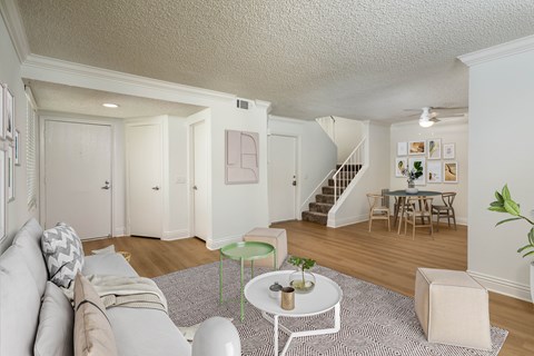A living room with a grey couch and a white coffee table.