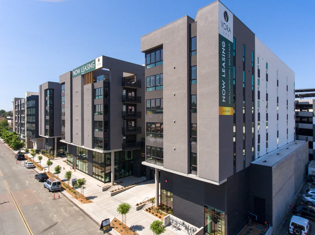 a view from above of a large grey building with a green sign on the side of it at VORA LUX, California