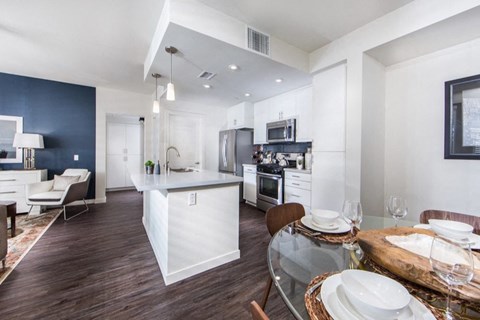 a kitchen and dining room with a table and chairs