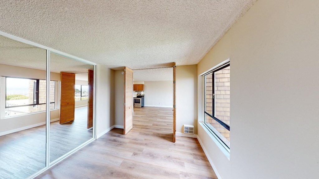 a view from the living room into the kitchen and dining room