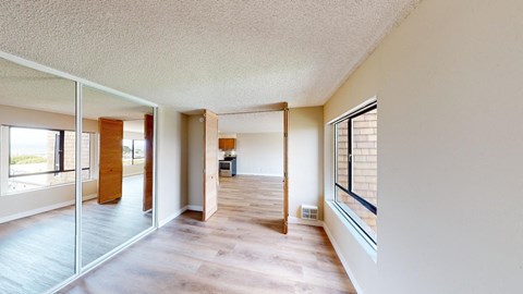 a view from the living room into the kitchen and dining room
