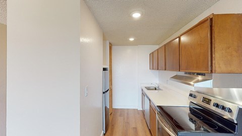 a kitchen with white countertops and wood cabinets