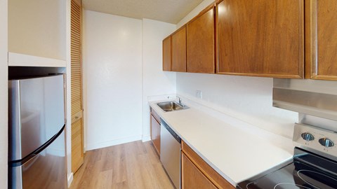 a kitchen with white countertops and wooden cabinets